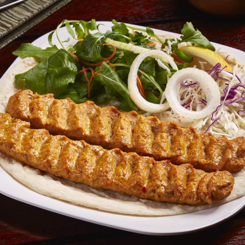 spicy-bbq-lamb-kabab-with-salad-lemon-bread-served-dish-isolated-table-side-view-middle-east-food-min